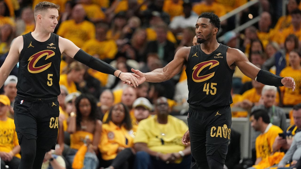 Cleveland Cavaliers guard Sam Merrill (5) and guard Donovan Mitchell (45) celebrate during the second half of Game 3 in the Eastern Conference semifinals of the NBA basketball playoffs against the Indiana Pacers in Indianapolis, Friday, May 9, 2025. (AP Photo/Michael Conroy)