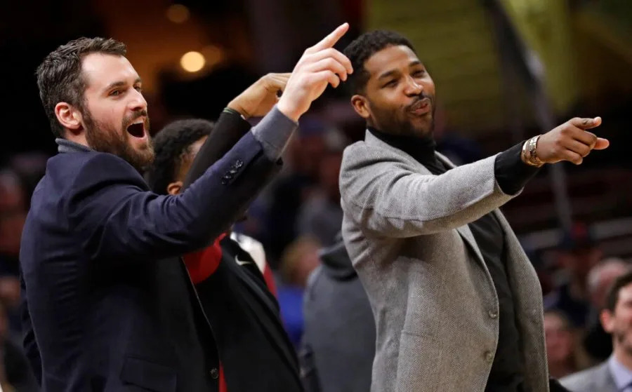 Cleveland Cavaliers’ Kevin Love, left, and Tristan Thompson give support to teammates from the bench in the first half of an NBA basketball game against the Washington Wizards, Tuesday, Jan. 29, 2019, in Cleveland. The Cavaliers won 116-113. (AP Photo/Tony Dejak)