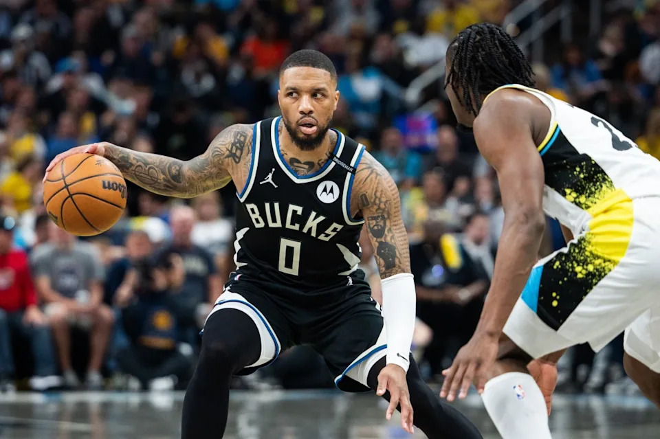 Milwaukee Bucks guard Damian Lillard (0) dribbles the ball while Indiana Pacers forward Aaron Nesmith (23) defends during game two of first round for the 2024 NBA Playoffs at Gainbridge Fieldhouse.Credit: Trevor Ruszkowski-Imagn Images