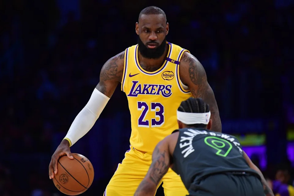 Los Angeles Lakers forward LeBron James controls the ball as Minnesota Timberwolves guard Nickeil Alexander-Walker defends during a playoff game at Crypto.com Arena.Gary A. Vasquez-Imagn Images