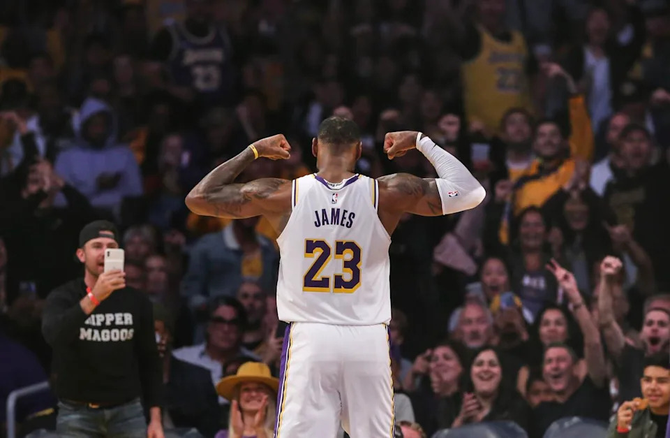 LeBron James flexes for the crowd during a game against the Hornets.