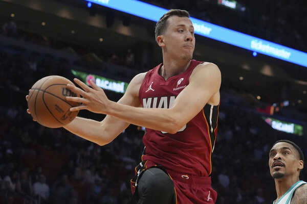 FILE - Miami Heat forward Duncan Robinson (55) passes the ball during the first half of an NBA basketball game against the Charlotte Hornets, March 10, 2025, in Miami. (AP Photo/Marta Lavandier, file) Duncan Robinson exercises option to terminate contract with Heat, though he could return to Miami