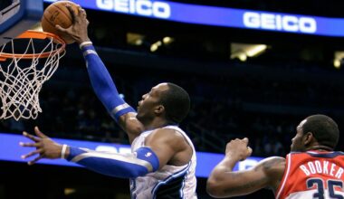Orlando Magic's Dwight Howard, left, dunks the ball in front of Washington Wizards' Trevor Booker (35) during the second half of an NBA basketball game Wednesday, Feb. 1, 2012, in Orlando, Fla. Orlando won 109-103. (AP Photo/John Raoux)