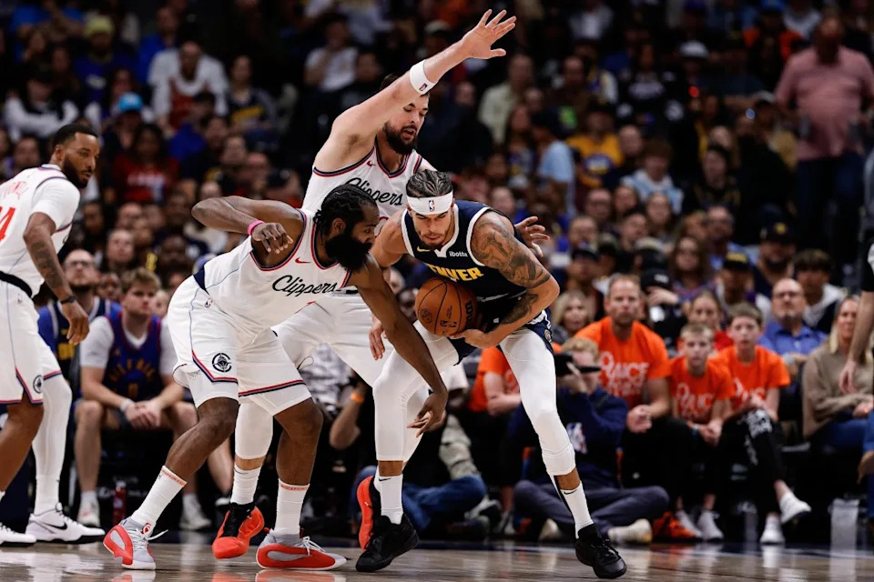 USA: Denver Nuggets forward Michael Porter Jr. (1) controls the ball under pressure from Los Angeles Clippers guard James Harden (1) and center Ivica Zubac (40) in the second quarter at Ball Arena.© Isaiah J. Downing-Imagn Images