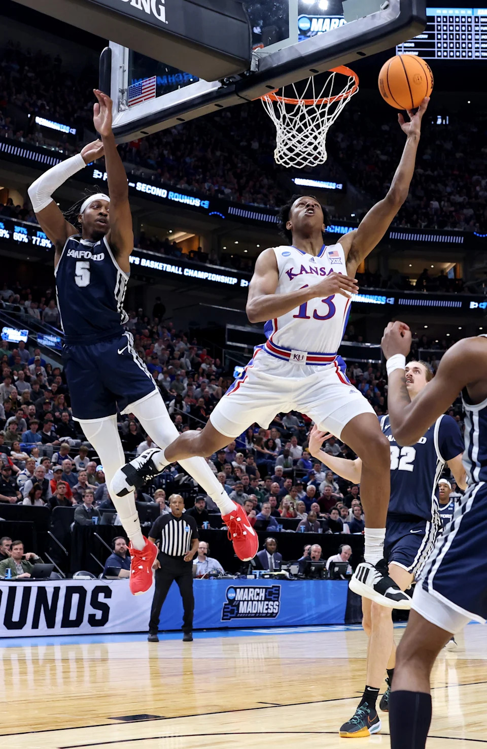 March 21, 2024; Salt Lake City, UT; Kansas basketball guard Elmarko Jackson (13) drives against Samford during a NCAA tournament game.