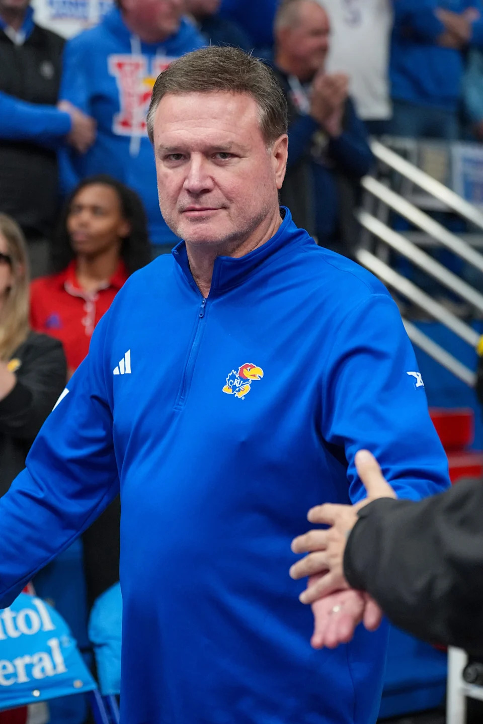 Feb. 22, 2025; Lawrence, Kansas; Kansas basketball coach Bill Self greets fans while entering the court prior to a game against Oklahoma State at Allen Fieldhouse.