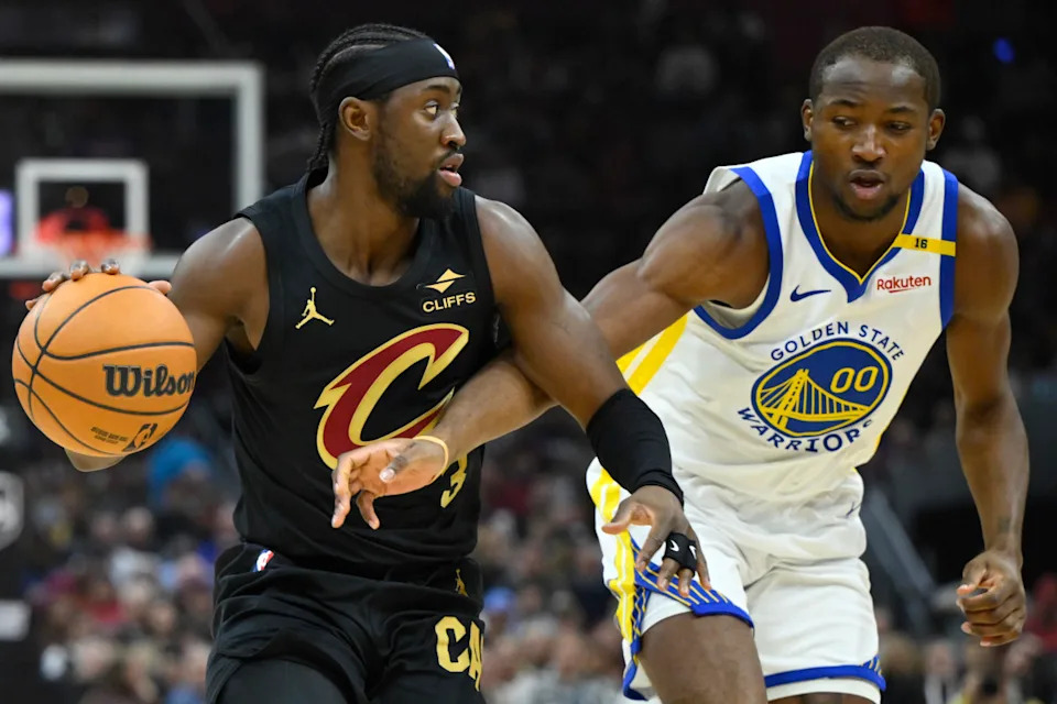 Nov 8, 2024; Cleveland, Ohio, USA; Golden State Warriors forward Jonathan Kuminga (00) defends Cleveland Cavaliers guard Caris LeVert (3) in the first quarter at Rocket Mortgage FieldHouse. © David Richard-Imagn Images