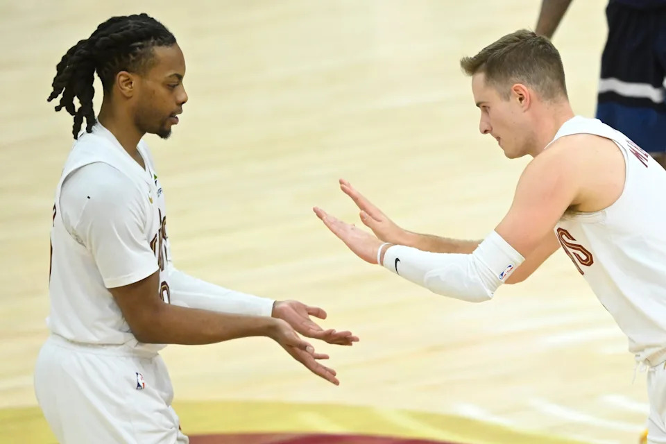 Feb 10, 2025; Cleveland, Ohio, USA; Cleveland Cavaliers guard Darius Garland (10) and guard Sam Merrill (5) celebrate in the fourth quarter against the Minnesota Timberwolves at Rocket Mortgage FieldHouse. Mandatory Credit: David Richard-Imagn Images