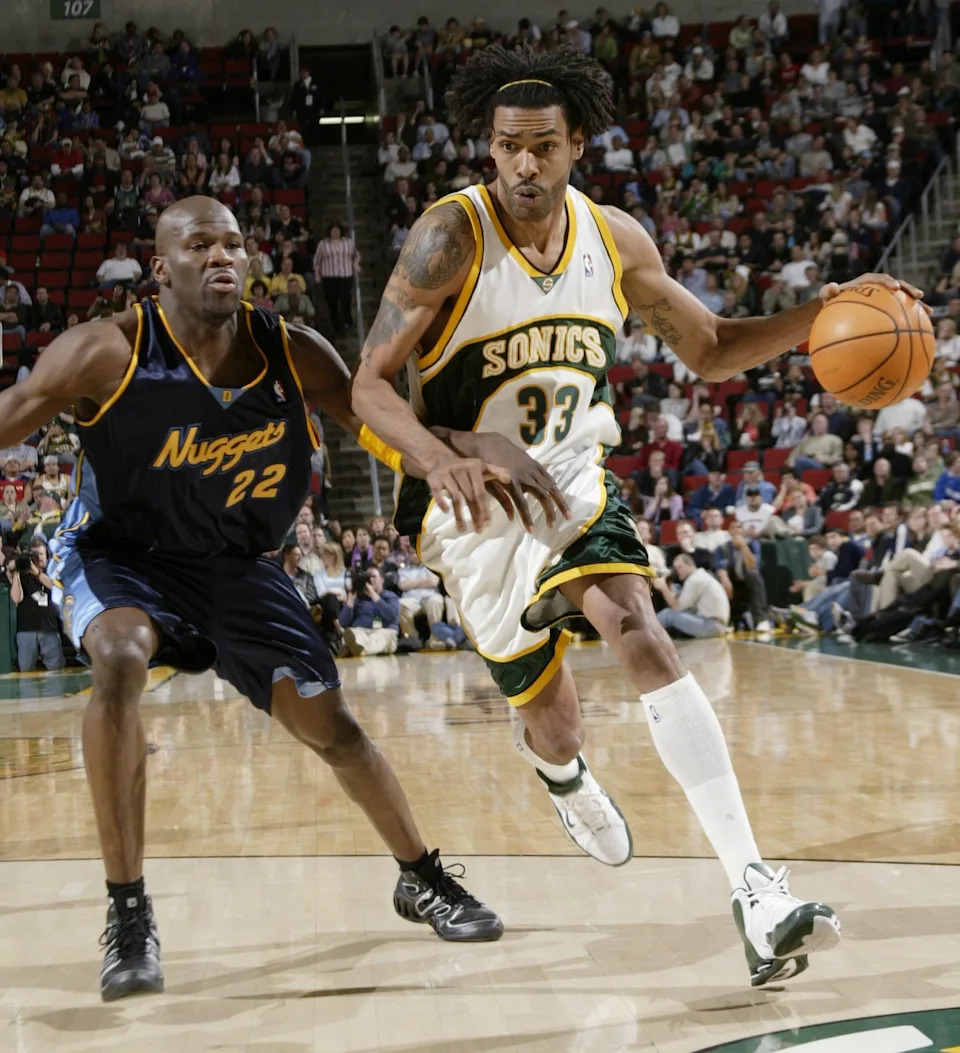 SEATTLE - APRIL 19: Mikki Moore #33 of the Seattle SuperSonics drives against Ruben Patterson #22 of the Denver Nuggets on April 19, 2006 at Key Arena in Seattle, Washington. The Sonics defeated the Nuggets 109-98. NOTE TO USER: User expressly acknowledges and agrees that, by downloading and/or using this Photograph, user is consenting to the terms and conditions of the Getty Images License Agreement. (Photo by Otto Greule/Getty Images)
