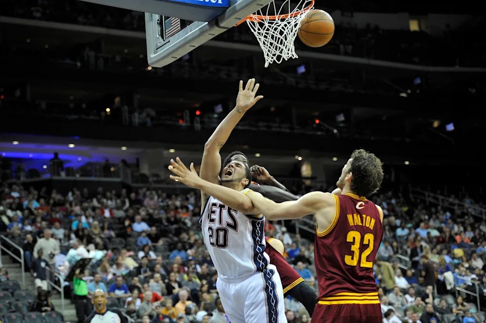 Apr 8, 2012; Newark, NJ, USA; New Jersey Nets forward Jordan Williams (20) is fouled by Cleveland Cavaliers forward Luke Walton (32) during the first half at the Prudential Center. Mandatory Credit: Joe Camporeale-USA TODAY Sports