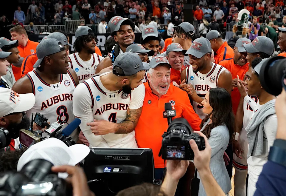 Mar 30, 2025; Atlanta, GA, USA; Auburn Tigers head coach Bruce Pearl and his team celebrate after winning the South Regional final of the 2025 NCAA tournament against the Michigan State Spartans at State Farm Arena. Mandatory Credit: Dale Zanine-Imagn Images