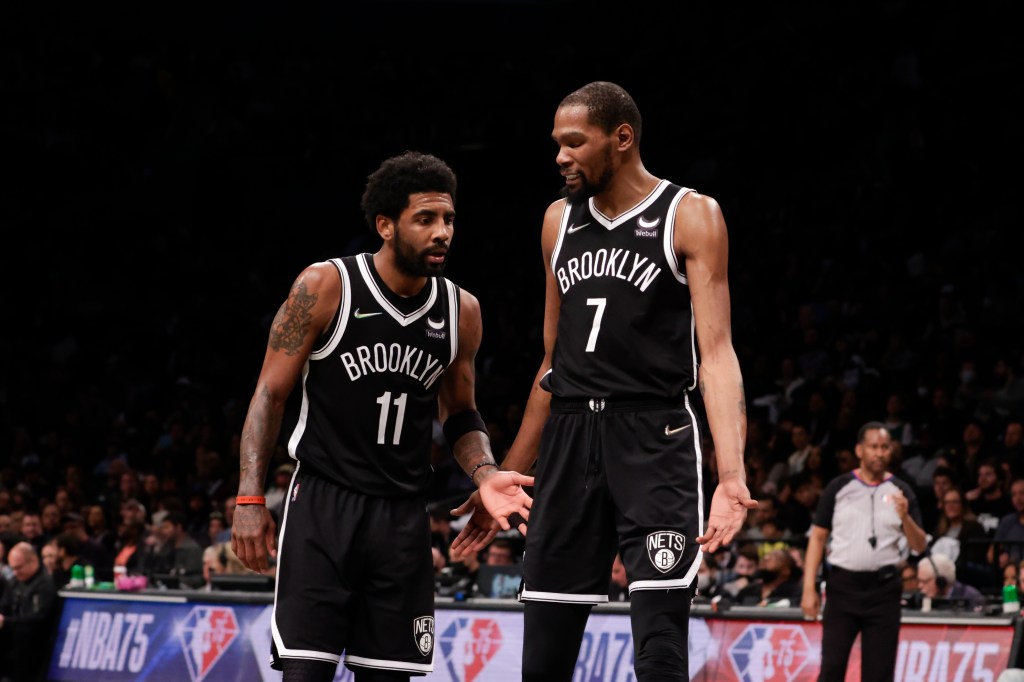Brooklyn Nets guard Kyrie Irving (11) and  forward Kevin Durant (7) react in the second half of Game 3 of the first round NBA playoffs against the Boston Celtics, Saturday, April 23, 2022, in Brooklyn, NY.
