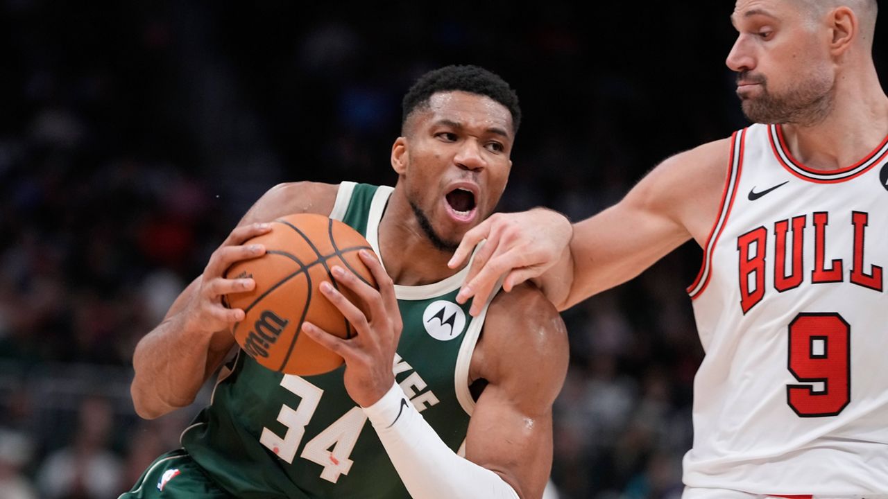 Milwaukee Bucks' Giannis Antetokounmpo drives on Chicago Bulls' Nikola Vucevic during the second half of an NBA basketball game.