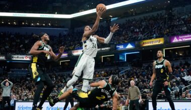 Indiana Pacers' Andrew Nembhard (2) defends as Milwaukee Bucks' Giannis Antetokounmpo (34) goes up for the basket during the second half of an NBA basketball game, Thursday, Nov. 9, 2023, in Indianapolis. Nembhard was called for a blocking foul on the play. (AP Photo/Darron Cummings)
