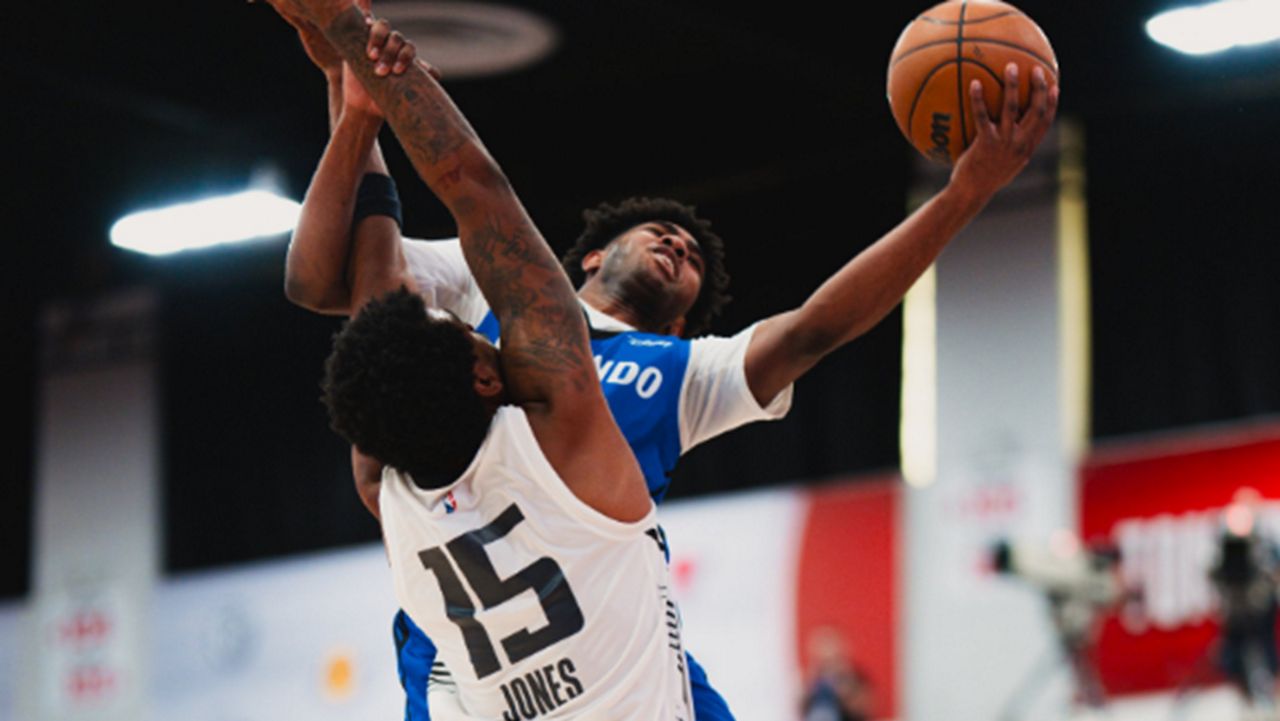 Magic rookie guard Jase Richardson reaches around Kings guard Mason Jones for a shot. (Photo courtesy of Orlando Magic)