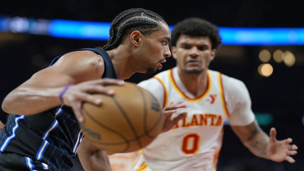 Orlando Magic guard Jett Howard (13) drives against Atlanta Hawks forward Dominick Barlow (0) during the first half of an NBA basketball game, Sunday, April 13, 2025, in Atlanta. (AP Photo/Mike Stewart)