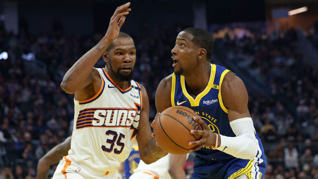Jonathan Kuminga #00 of the Golden State Warriors is guarded by Kevin Durant #35 of the Phoenix Sun...