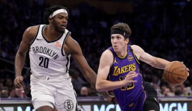 Los Angeles Lakers guard Austin Reaves, right ,drives toward the basket as Brooklyn Nets center Day'Ron Sharpe defends during the first half of an NBA basketball game, Friday, Jan. 17, 2025, in Los Angeles. (AP Photo/Mark J. Terrill)