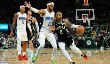 Milwaukee Bucks' Damian Lillard (0) drives to the basket against Orlando Magic's Trevelin Queen during the second half of an NBA basketball game Wednesday, Jan. 15, 2025, in Milwaukee.