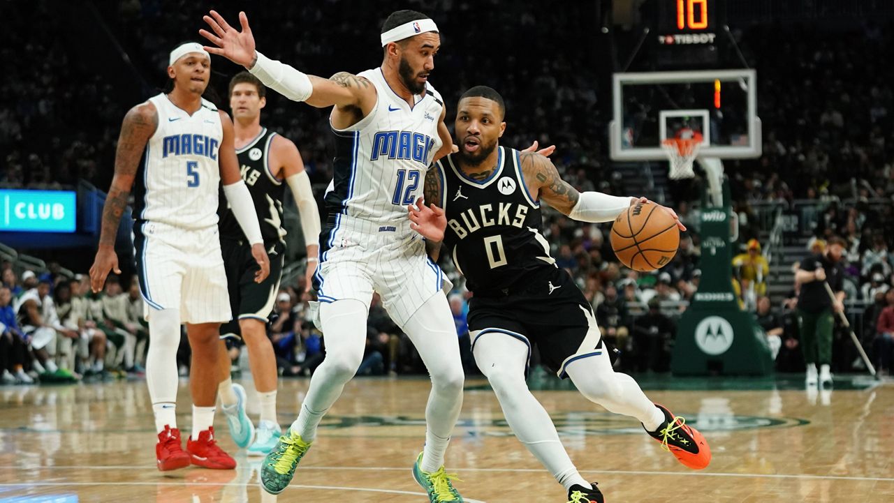 Milwaukee Bucks' Damian Lillard (0) drives to the basket against Orlando Magic's Trevelin Queen during the second half of an NBA basketball game Wednesday, Jan. 15, 2025, in Milwaukee.
