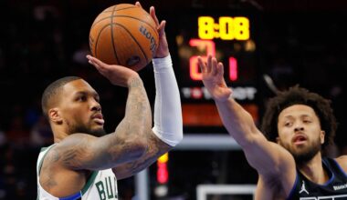 Milwaukee Bucks guard Damian Lillard takes a shot ahead of Detroit Pistons guard Cade Cunningham