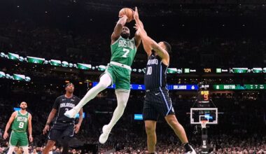 Boston Celtics guard Jaylen Brown (7) takes a shot while pressured by Orlando Magic guard Cory Joseph (10) during the first half in game 2 of a first-round NBA playoff basketball series, Wednesday, April 23, 2025, in Boston. (AP Photo/Charles Krupa)