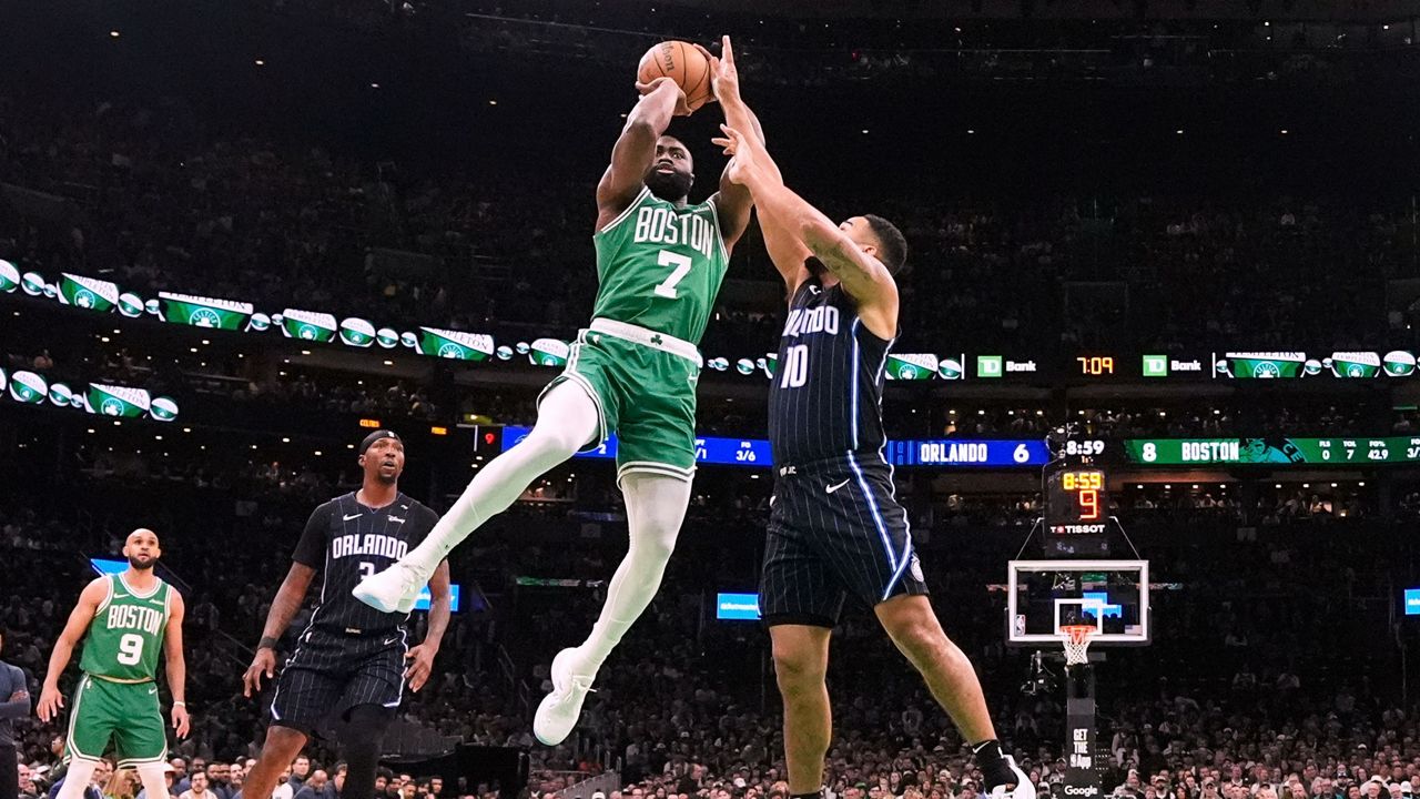 Boston Celtics guard Jaylen Brown (7) takes a shot while pressured by Orlando Magic guard Cory Joseph (10) during the first half in game 2 of a first-round NBA playoff basketball series, Wednesday, April 23, 2025, in Boston. (AP Photo/Charles Krupa)