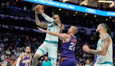 Charlotte Hornets center Nick Richards (4) is fouled going up for a shot by Phoenix Suns center Mason Plumlee (22) during the second half of an NBA basketball game in Charlotte, N.C., Tuesday, Jan. 7, 2025. (AP Photo/Jim Dedmon)