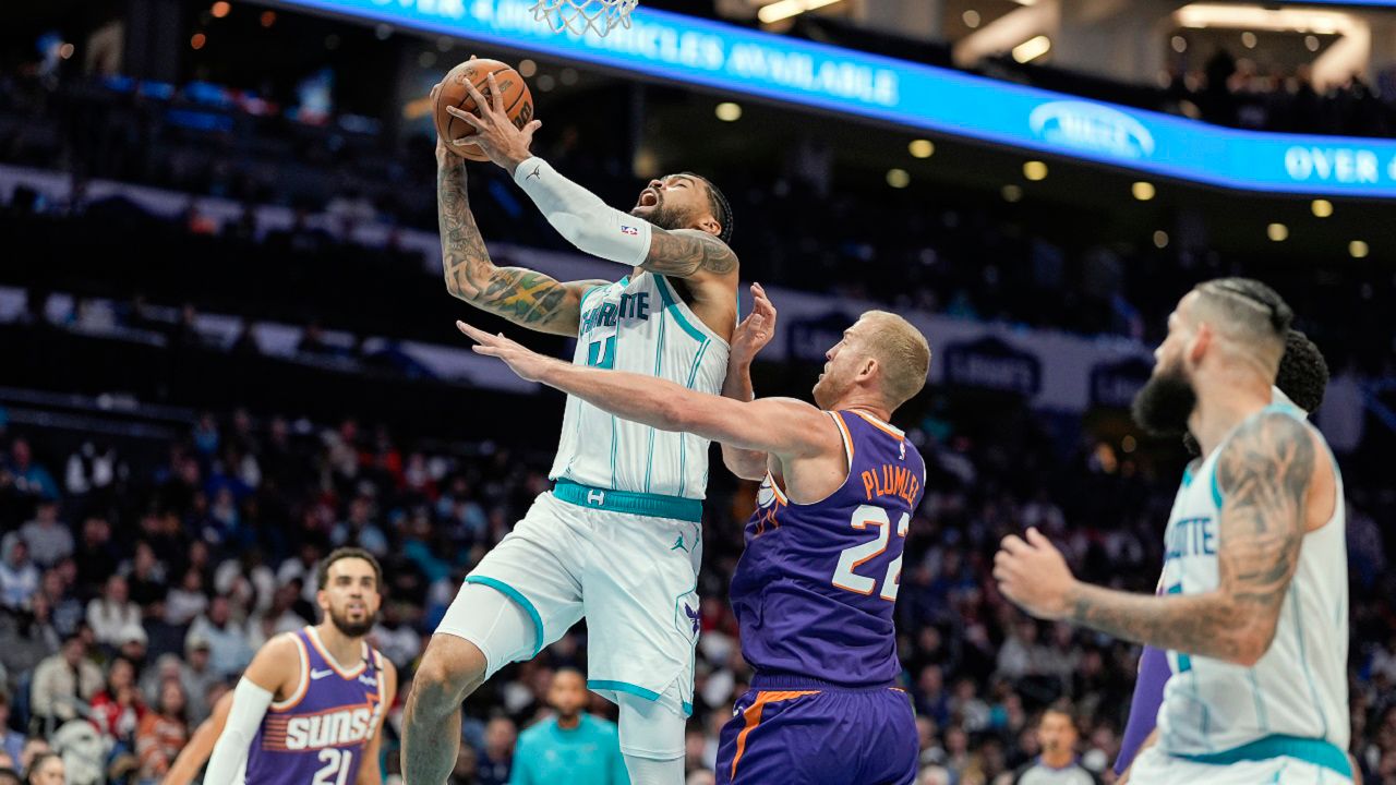 Charlotte Hornets center Nick Richards (4) is fouled going up for a shot by Phoenix Suns center Mason Plumlee (22) during the second half of an NBA basketball game in Charlotte, N.C., Tuesday, Jan. 7, 2025. (AP Photo/Jim Dedmon)
