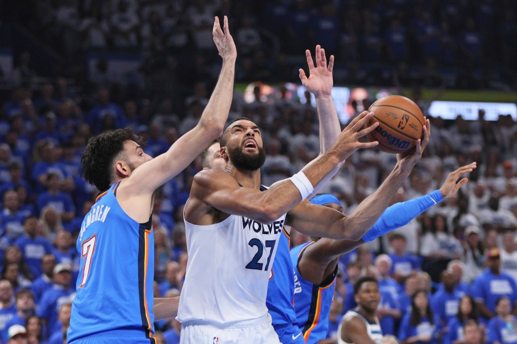 A basketball player shoots the ball during a game.