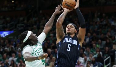 Orlando Magic's Paolo Banchero (5) shoots against Boston Celtics' Jrue Holiday (4) during the second half in Game 1 of a first-round NBA playoff basketball series Sunday, April 20, 2025, in Boston. (AP Photo/Michael Dwyer)