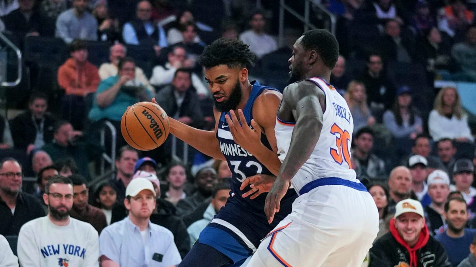 Karl-Anthony Towns, then of the Timberwolves, drives right as Julius Randle, then of the Knicks defends.