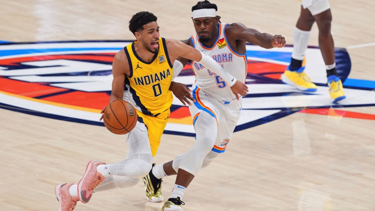 Indiana Pacers guard Tyrese Haliburton (0) drives past Oklahoma City Thunder guard Luguentz Dort (5) during the second half of Game 5 of the NBA Finals basketball series, Monday, June 16, 2025, in Oklahoma City. (AP Photo/Kyle Phillips)