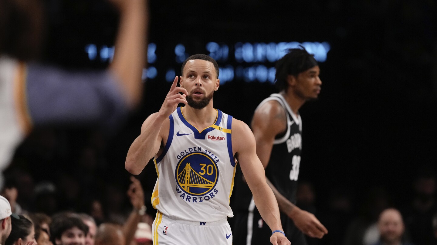 Curry scores 40 points and the Warriors finish a 4-1 trip with a 121-119 victory over the Nets