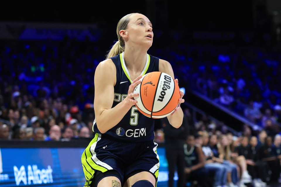 Paige Bueckers #5 of the Dallas Wings dribbling the ball during a WNBA game.