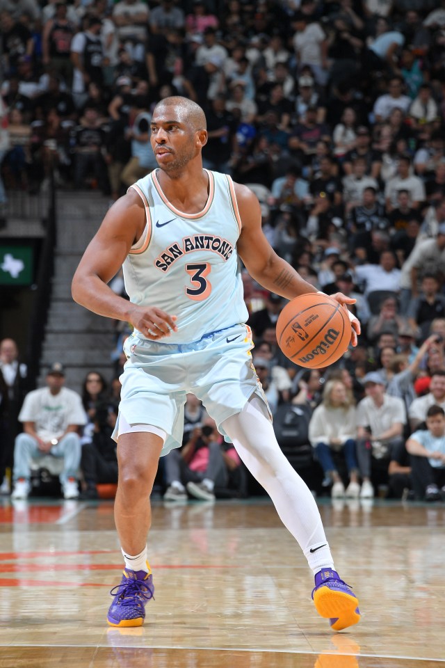 Chris Paul #3 of the San Antonio Spurs dribbling a basketball.