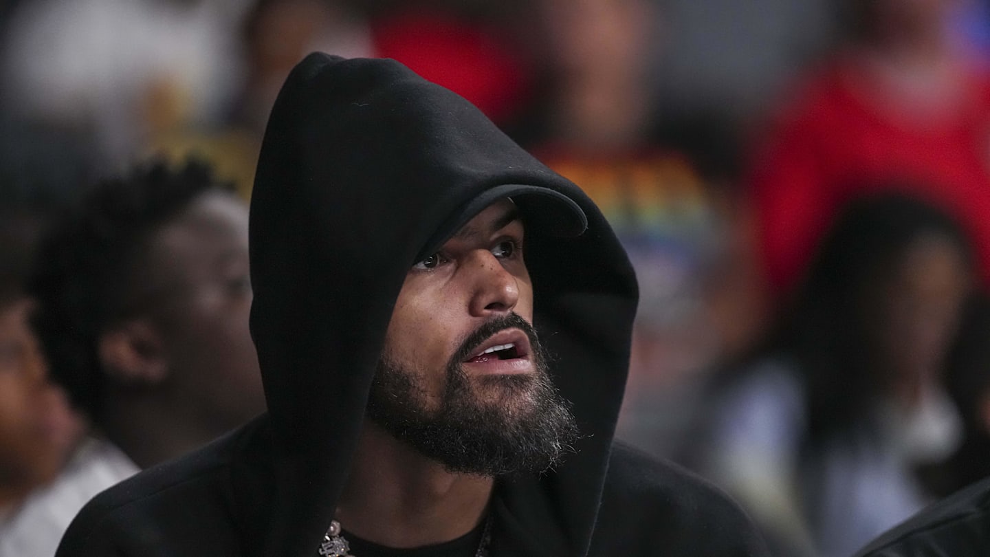 Atlanta Hawks player Trae Young watches the game between the Atlanta Dream against the Minnesota Lynx during the first half at Gateway Center Arena at College Park.