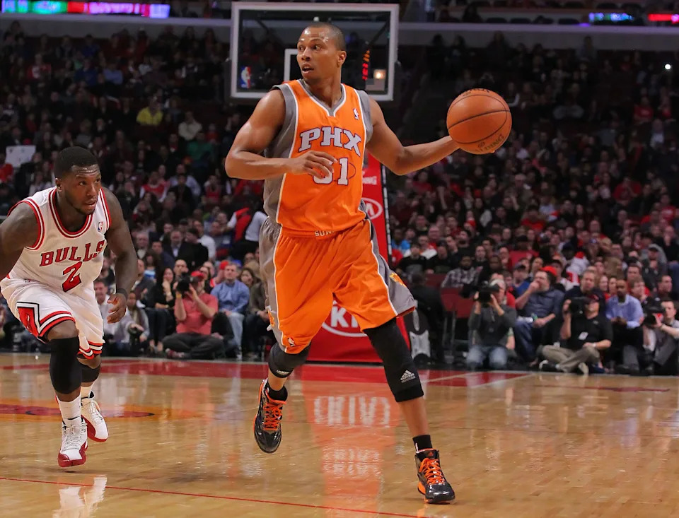 Phoenix Suns point guard Sebastian Telfair drives past Chicago Bulls point guard Nate Robinson during a game at the United Center.