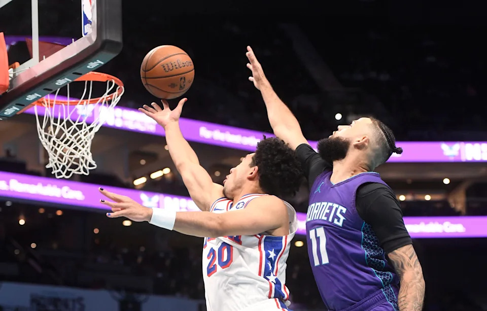 Dec 3, 2024; Charlotte, North Carolina, USA; Philadelphia 76ers guard Jared McCain (20) drives in past Charlotte Hornets guard Cody Martin (11) during the first half at the Spectrum Center. Mandatory Credit: Sam Sharpe-Imagn Images