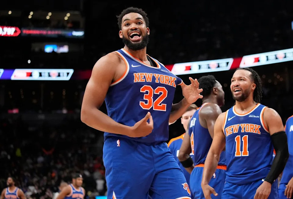 Dec 9, 2024; Toronto, Ontario, CAN; New York  Knicks guard Jalen Brunson (11) watches as center Karl-Anthony Towns (32) celebrates after making a three point basket to clinch a win against the Toronto Raptors near the end of the fourth quarter at Scotiabank Arena. Mandatory Credit: John E. Sokolowski-Imagn Images