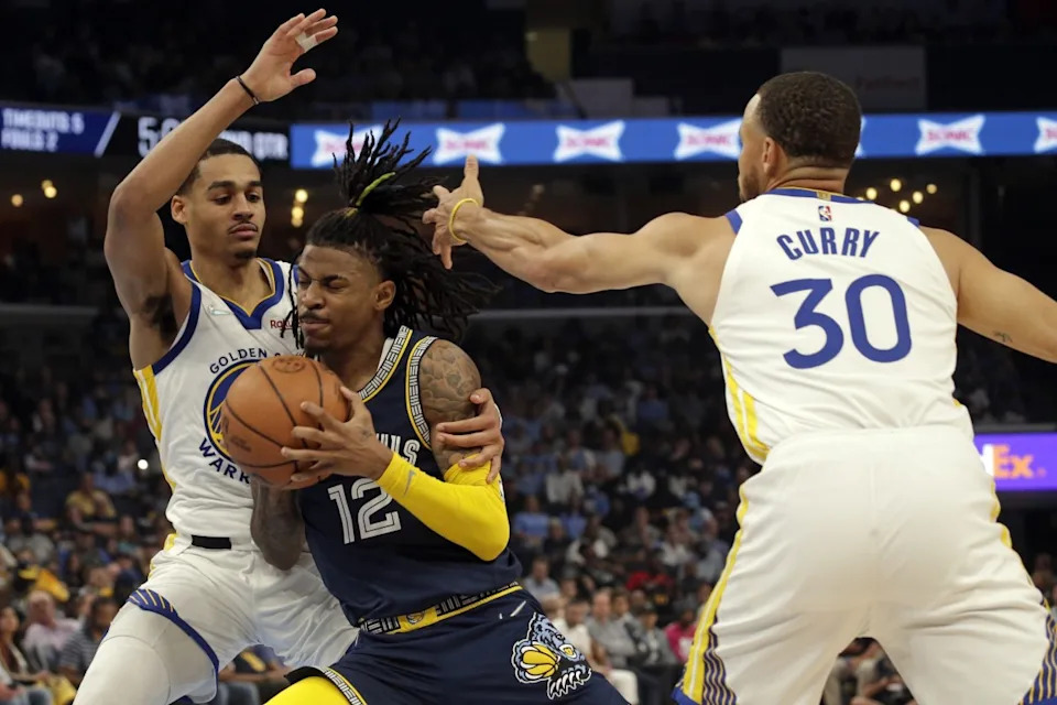 USA: Memphis Grizzlies guard Ja Morant (12) drives to the basket as Golden State Warriors guards Jordan Poole (3) and Stephen Curry (30) defend during the first half in game two of the second round for the 2022 NBA playoffs at FedExForum.© Petre Thomas-USA Today Sports