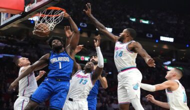 Orlando Magic forward Jonathan Isaac (1) dunks over Miami Heat center Bam Adebayo (13) and forward Haywood Highsmith (24) during the first half of an NBA basketball game, Monday, Jan. 27, 2025, in Miami. (AP Photo/Lynne Sladky)
