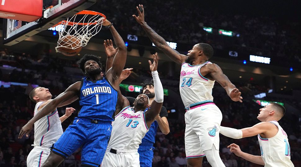 Orlando Magic forward Jonathan Isaac (1) dunks over Miami Heat center Bam Adebayo (13) and forward Haywood Highsmith (24) during the first half of an NBA basketball game, Monday, Jan. 27, 2025, in Miami. (AP Photo/Lynne Sladky)