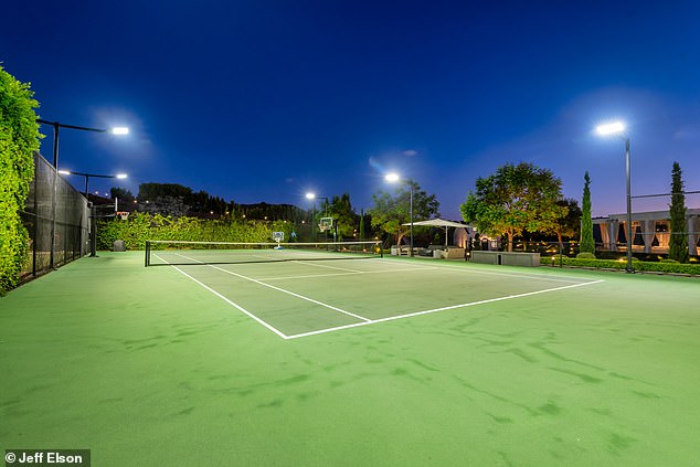 The property boasts a number of amenities including a full-size tennis court in the garden