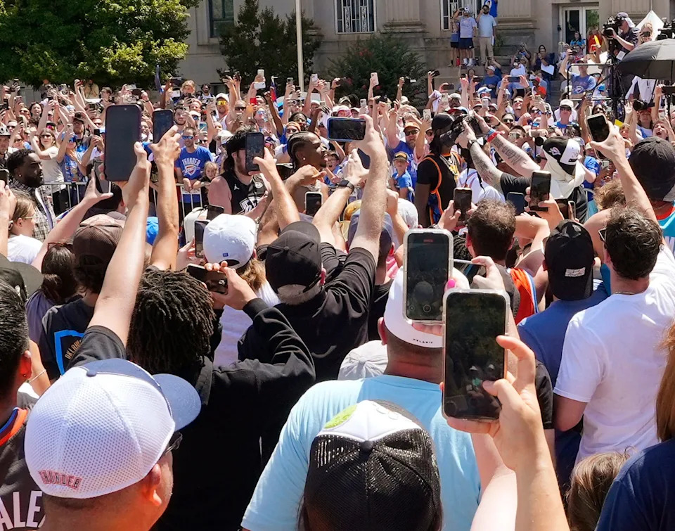 Shai Gilgeous-Alexander walks past the crowd. Fans watch the parade in the area of City Hall and Bicentennial Park. The Oklahoma City Thunder celebrate their first NBA Finals title win with a champions parade throughout downtown Oklahoma City, Tuesday, June 24, 2025.