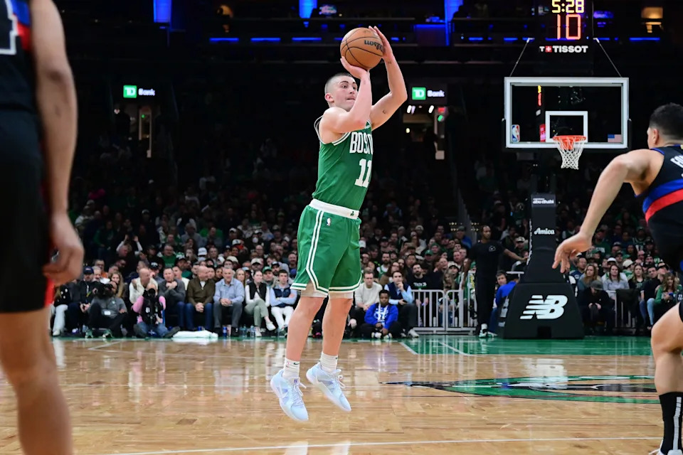 Dec 12, 2024; Boston, Massachusetts, USA; Boston Celtics guard Payton Pritchard (11) shoots a three point basket during the second half against the Detroit Pistons at TD Garden. Mandatory Credit: Eric Canha-Imagn Images
