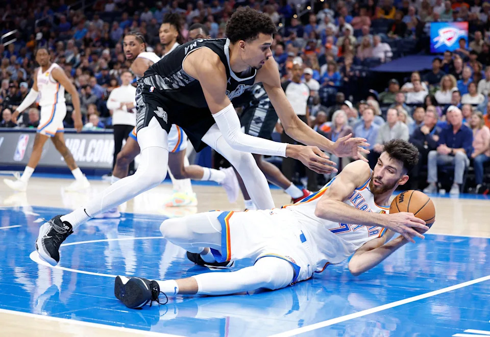 Oct 30, 2024; Oklahoma City, Oklahoma, USA; San Antonio Spurs center Victor Wembanyama (1) works to steal the ball from Oklahoma City Thunder forward Chet Holmgren (7) after he fell to the floor during the second half at Paycom Center. Mandatory Credit: Alonzo Adams-Imagn Images