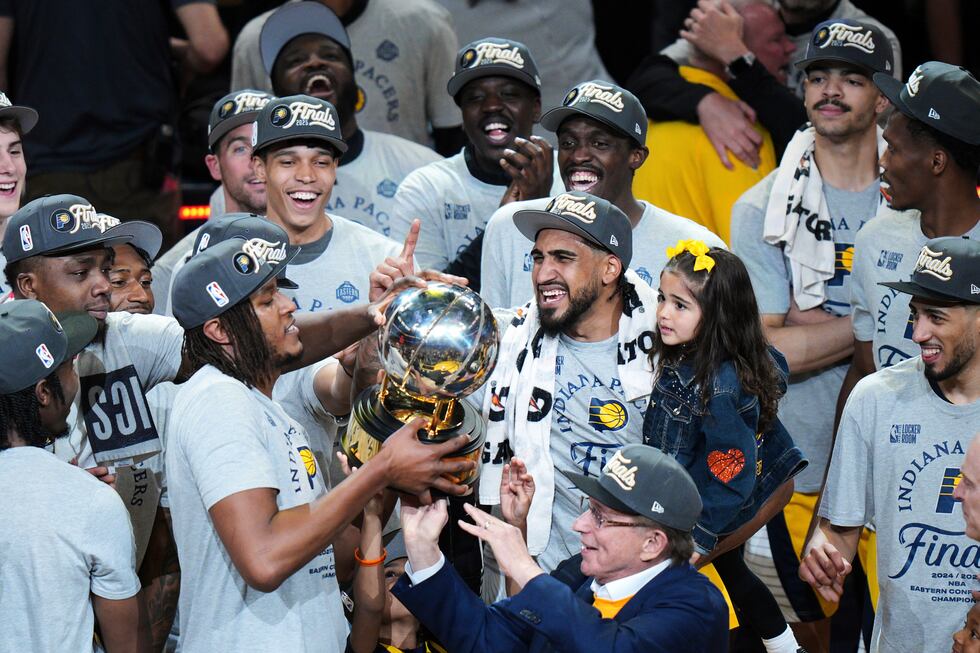 Indiana Pacers players celebrate with the trophy after winning Game 6 of the Eastern...