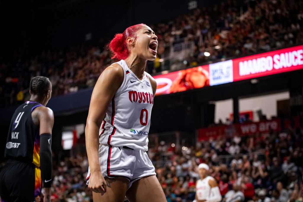 Washington Mystics center/forward Shakira Austin shouts as she reacts to a play. She is shown by herself, at a 45-degree angle.