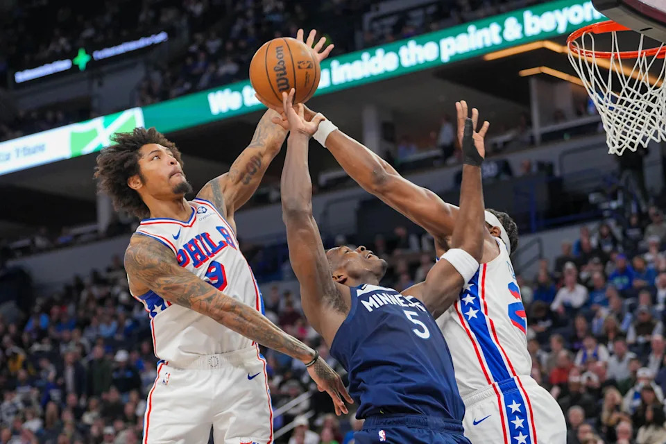 Mar 4, 2025; Minneapolis, Minnesota, USA; Philadelphia 76ers guard Kelly Oubre Jr. (9) blocks Minnesota Timberwolves guard Anthony Edwards (5) in the second quarter at Target Center. Mandatory Credit: Brad Rempel-Imagn Images